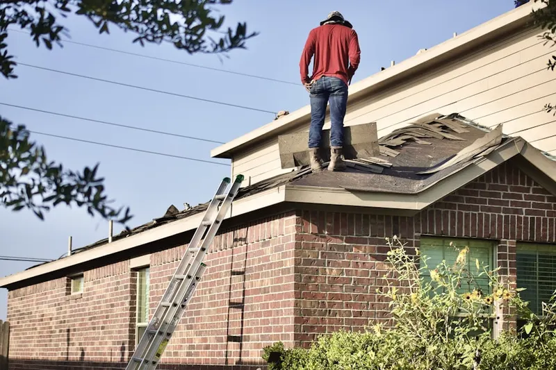 Professional roofer working on a residential roof in Windy Oaks